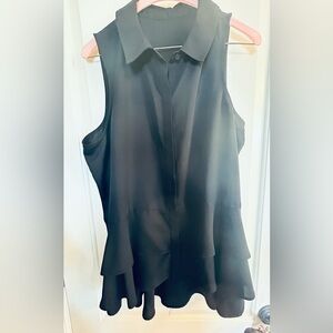 Sleeveless blouse 100% polyester for easy care. Bottom down with relaxed ruffles